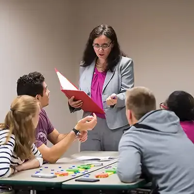 Professor providing practical healthcare instruction.